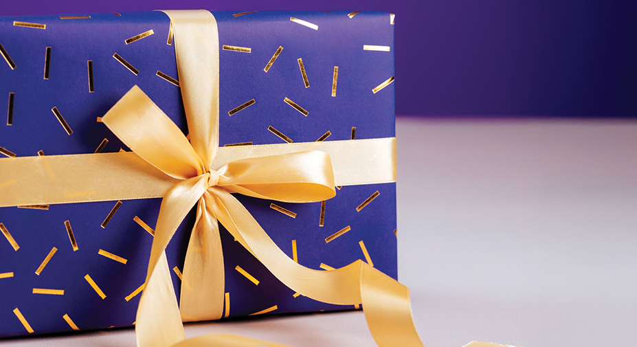 Pöydällä on kauniisti paketoitu lahjapaketti.